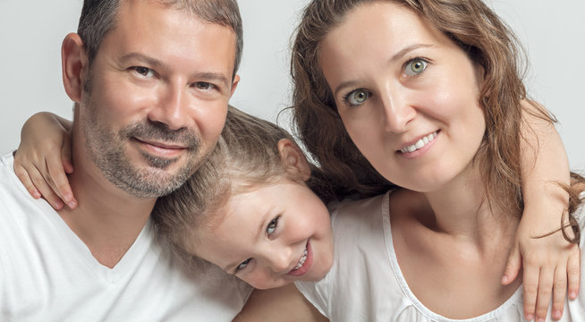 portrait of happy family. Beautiful cute little daughter and her parents.
