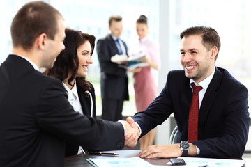 Fototapeta na wymiar Business people shaking hands, finishing up a meeting