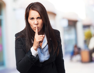 cool business-woman doing silence sign