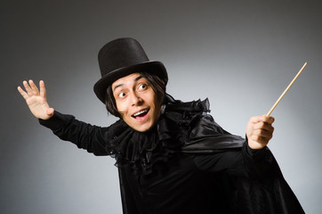 Funny magician wearing cylinder hat