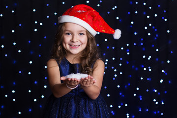 Happy girl with white snowflakes in a studio 