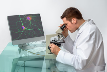 Fototapeta na wymiar Senior male scientist observes sample under the microscope