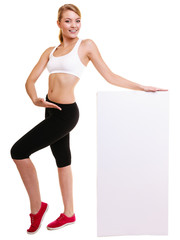 Fitness sporty woman holding blank empty ad banner