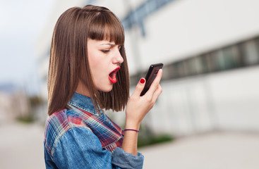 portrait of worried young girl talking on mobile phone