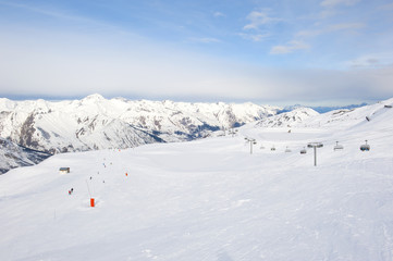 Fototapeta na wymiar View down a snowy ski piste