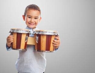 portrait of a little boy holding a drum