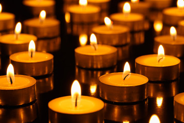 Many burning candles with shallow depth of field