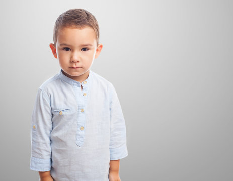 Portrait Of A Little Boy With Serious Gesture