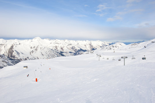 View down a snowy ski piste