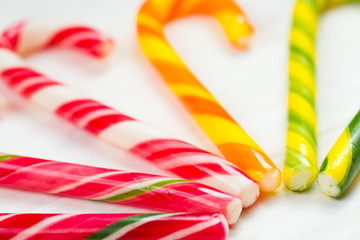 Christmas candy cane on a white wooden background