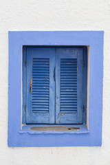 Obraz na płótnie Canvas Window with closed blue shutters