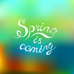 Spring is coming had written text, calligraphy lettering on blurred background