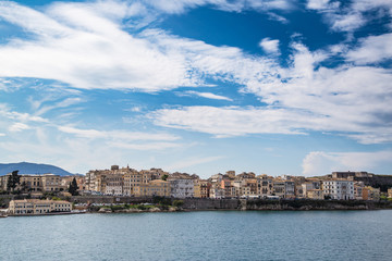 Fototapeta na wymiar Corfu island cityscape from the sea with blue waters and sky.