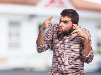 portrait of a young man doing a crazy gesture