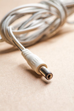 Laptop AC adapter plug on brown craft paper