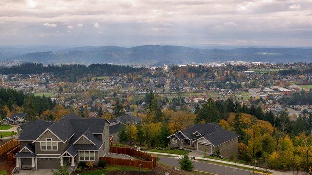 Time Lapse movie of thick moving clouds and sun rays over city of Happy Valley Oregon residential suburbs homes landscape in colorful fall autumn season uhd 4k 4096x2304