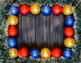 New year theme: christmas decoration and balls on dark retro stylized wood background