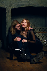 Fototapeta na wymiar Young woman and man sitting on the floor in wine vault
