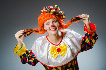 Clown in funny concept on dark background