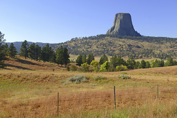 Devils Tower National Monument, a geological landform rising from the grasslands of Wyoming, is a popular tourist attraction, source for Native American legend and rock climbing goal for climbers