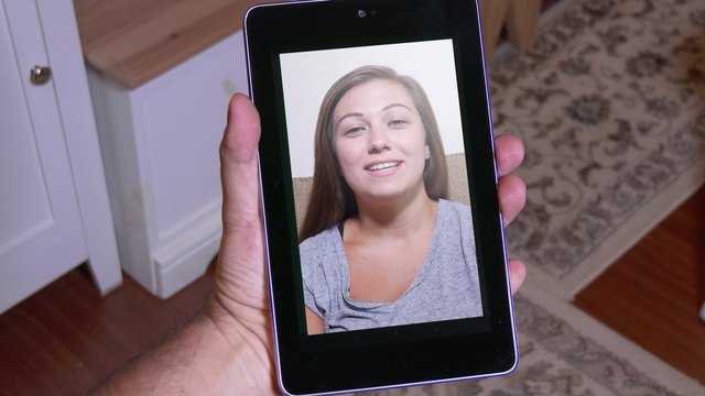 A person gets a pop-up warning about nearly reaching the monthly data limit while video chatting.	