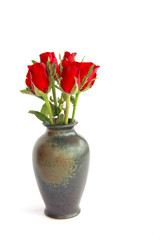 Stock Photo:.Beautiful red roses in a vase isolated on white