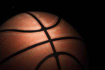 Close up of old basketball on dark background