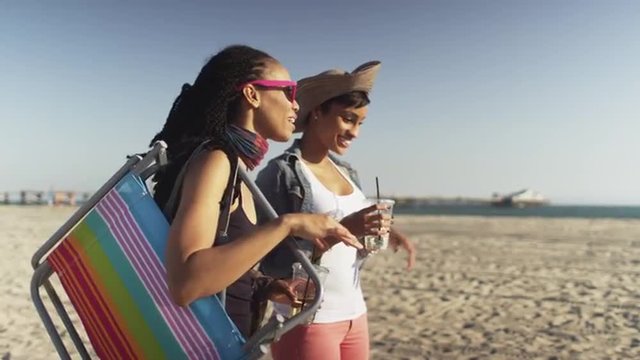 Black Friends Sipping Iced Tea And Hanging Out On The Beach