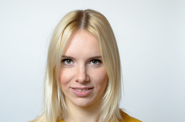 Face of a Young Woman Against Gray Background