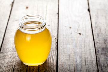 Bowl of honey on wooden table. Symbol of healthy living and natural medicine. Aromatic and tasty.
