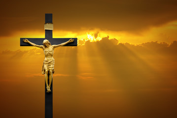 Jesus Christ on the cross over sunrise background