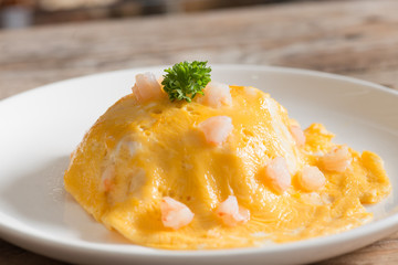 Scrambled egg shrimp on white plate.