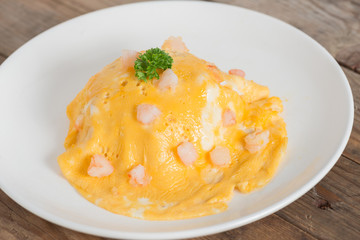 Scrambled egg with shrimp on white plate.