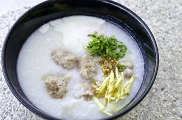 Thai rice porridge with pork in bowl