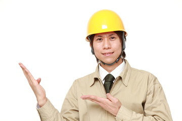 young Japanese construction worker presenting and showing something 