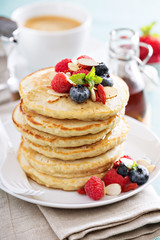 Fluffy oatmeal pancakes stack with fresh berries