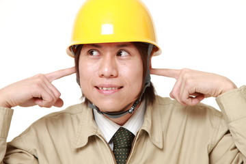 Young Japanese construction worker suffers from noise