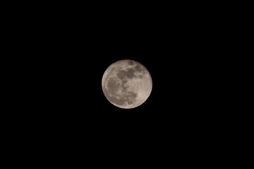 Full moon over dark black sky at night