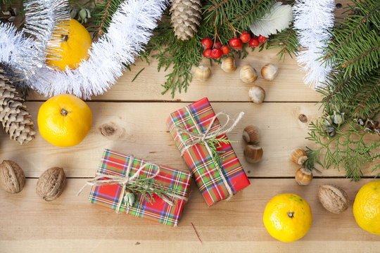 Christmas gift box with New Year's and Christmas decoration midst fruits and tinsel