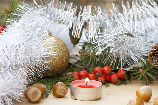 New Year and Christmas red candle on wooden table among Christmas and New Year ball and decor