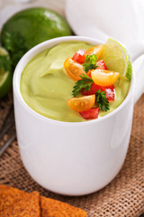 Cold avocado soup with tomato salsa