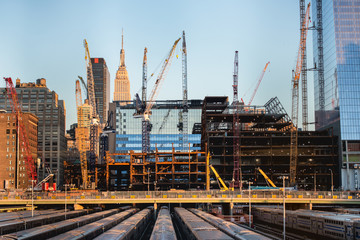 tall buildings under construction and cranes under a blue sky in New York City - 95529892