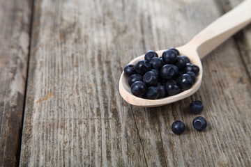 Ripe blackberries in a wooden spoon