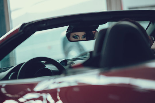 close up portrait of Young pretty brunette lady with a modern luxury car