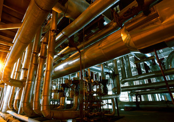 Equipment, cables and piping as found inside of a modern industr