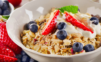 Breakfast with  berries, yogurt and  muesli.