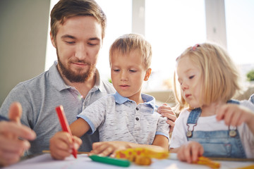 Father and kids drawing