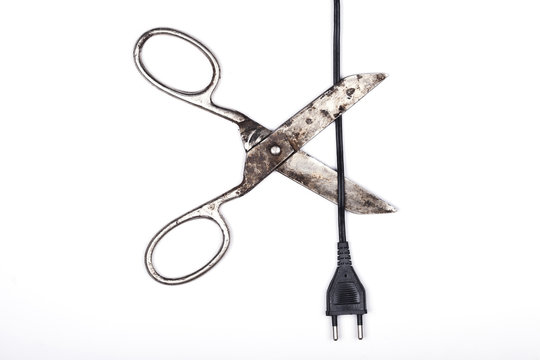 Scissors cutting the cord isolated on white background