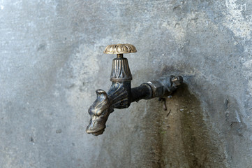 Old vintage style tap and rusty wall in Vinci ,italy
