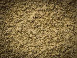 Yellow knobby cement wall for background